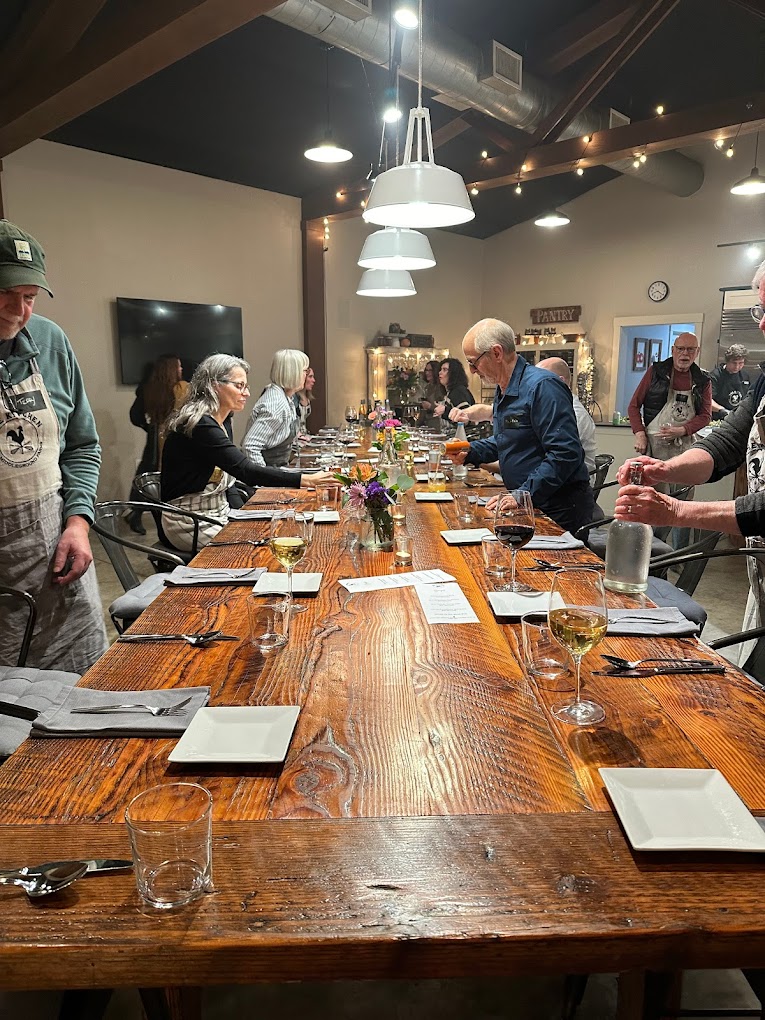 People prepare for a meal at The Kitchen At Middleground Farms.