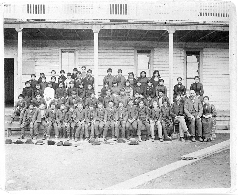 Students and staff stand in front of the Warm Springs Indian Training School, 1890.