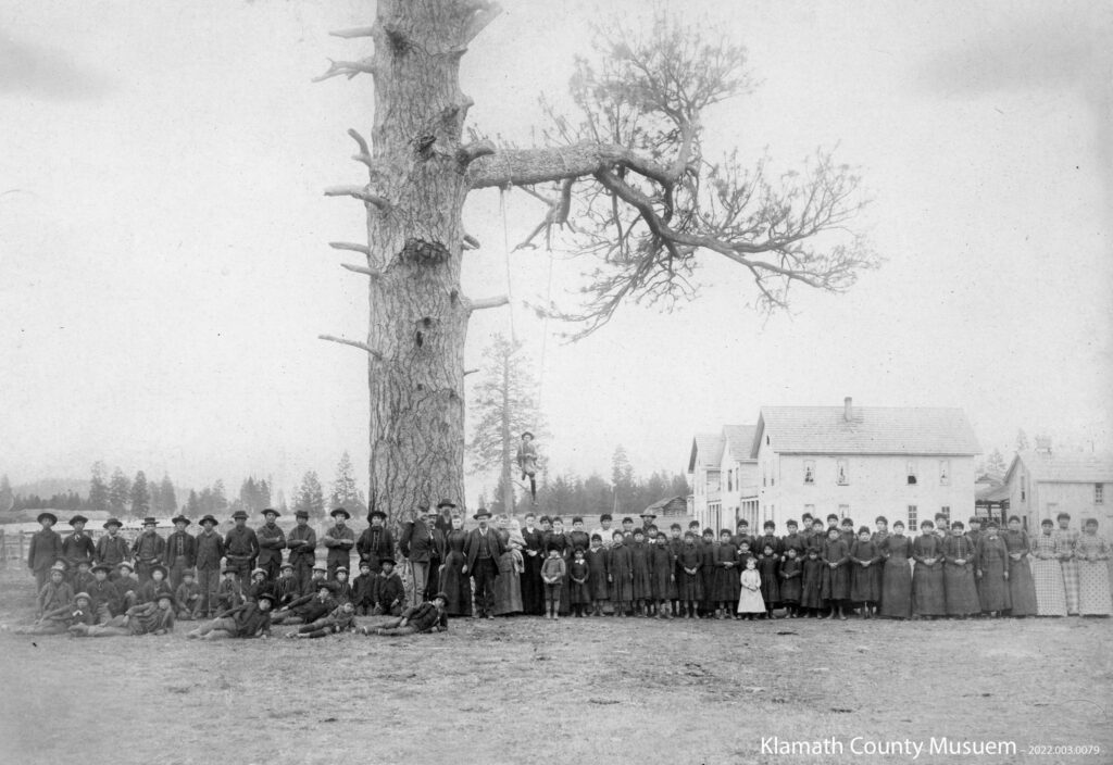 Children stand in uniform at the Yainax Subagency School in southern Oregon in 1892.