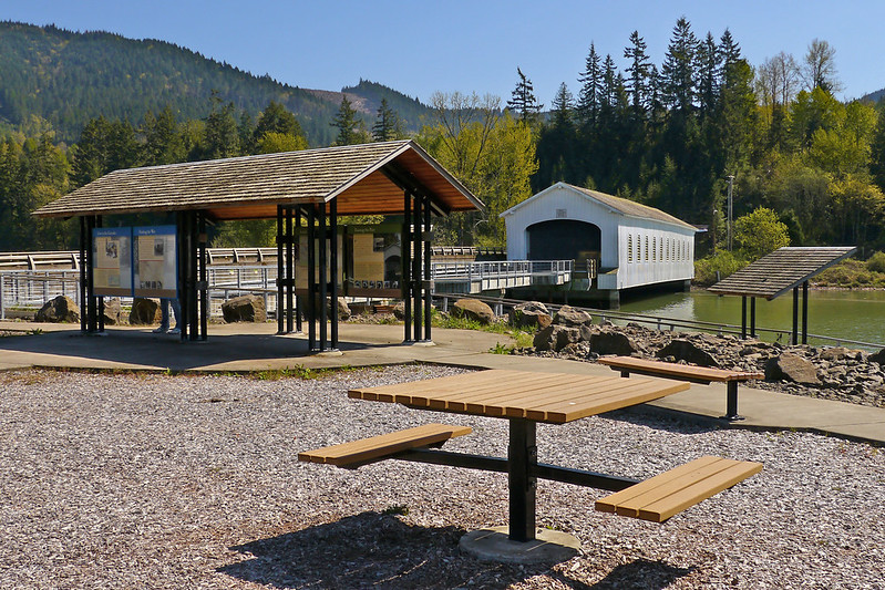 Picnic tables and interpretive signs outside Lowell Covered Bridge in Lowell, Oregon.