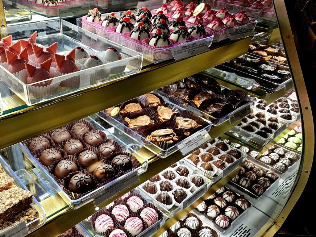 Baked treats in a display case. They look so cute and pretty!