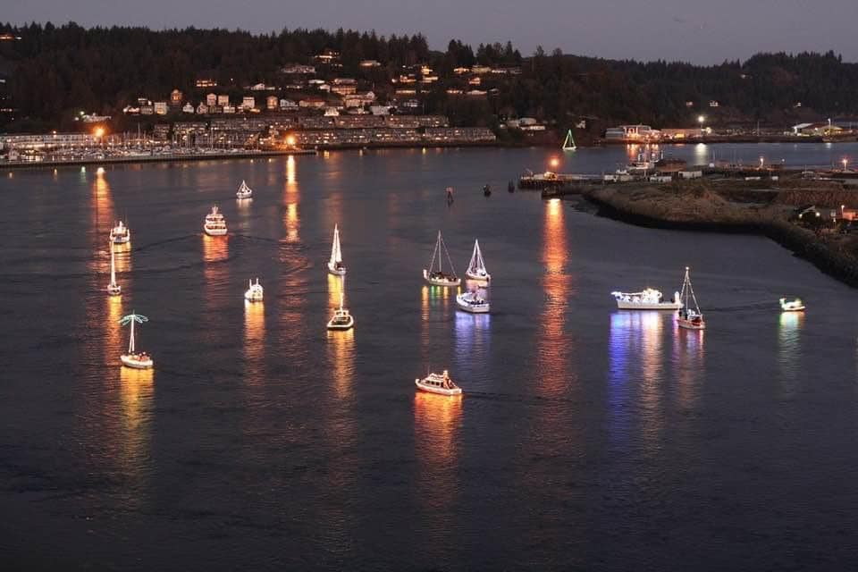 Boats with Christmas lights light up the night in Newport.