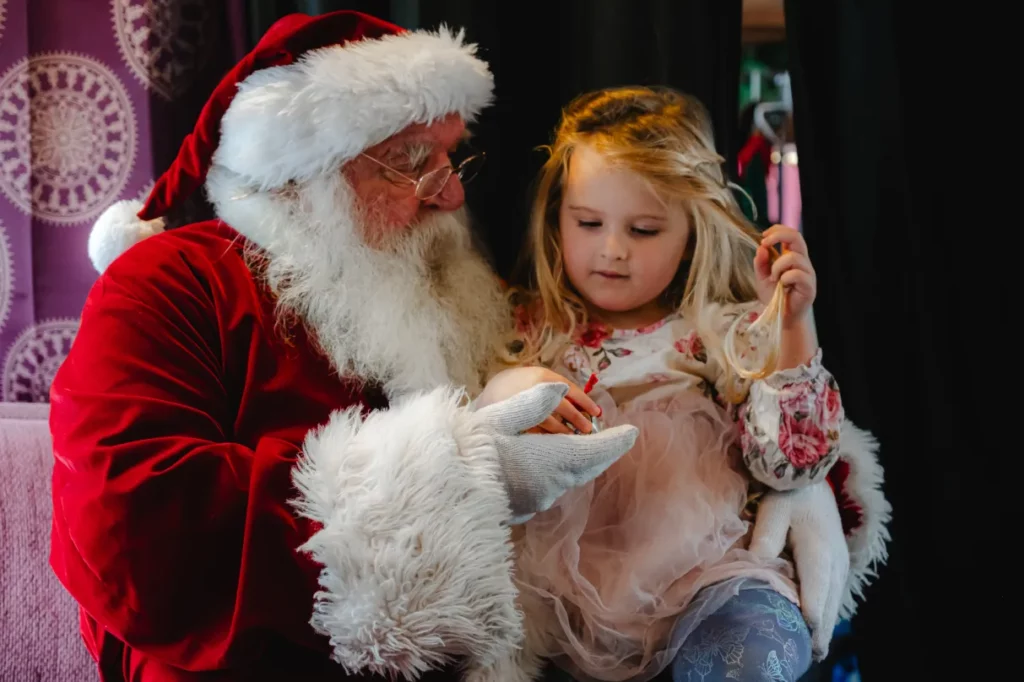 Santa and a little girl on the Christmas train.