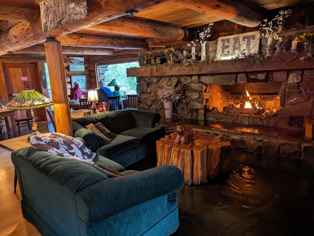 The cozy fireplace with couches in front.