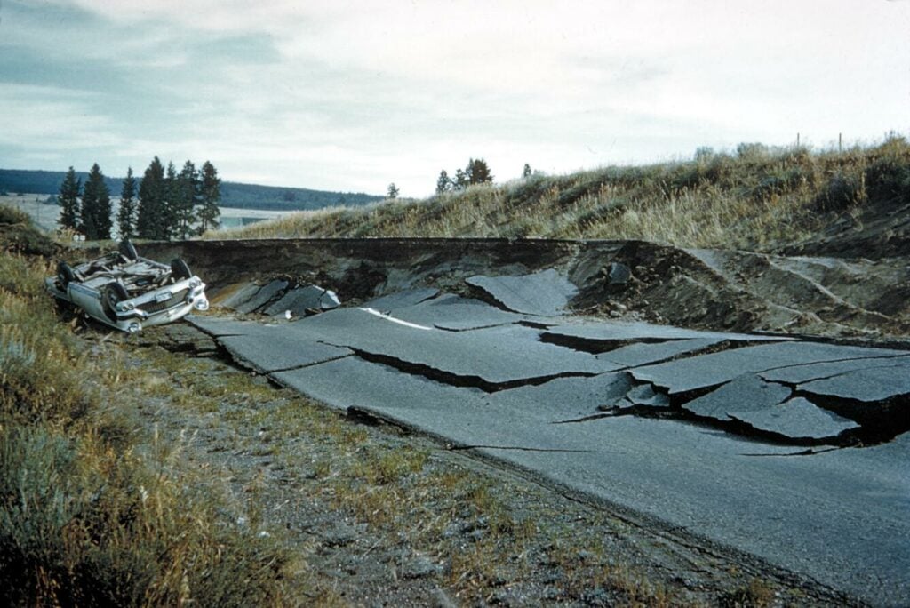 A road is completely destroyed and torn apart by an earthquake.