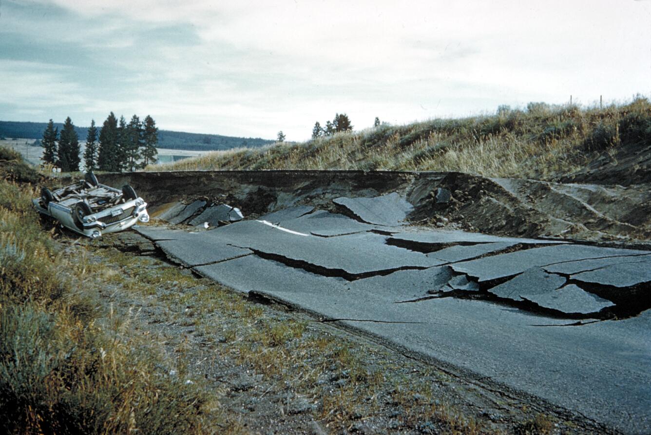 A road is completely destroyed and torn apart by an earthquake.