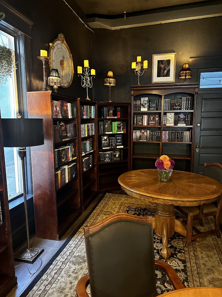 The interior of Daffodil Romantasy Books features a gorgeous dark academia aesthetic, cozy vibes, and lots of places to sit and enjoy coffee and a good book.