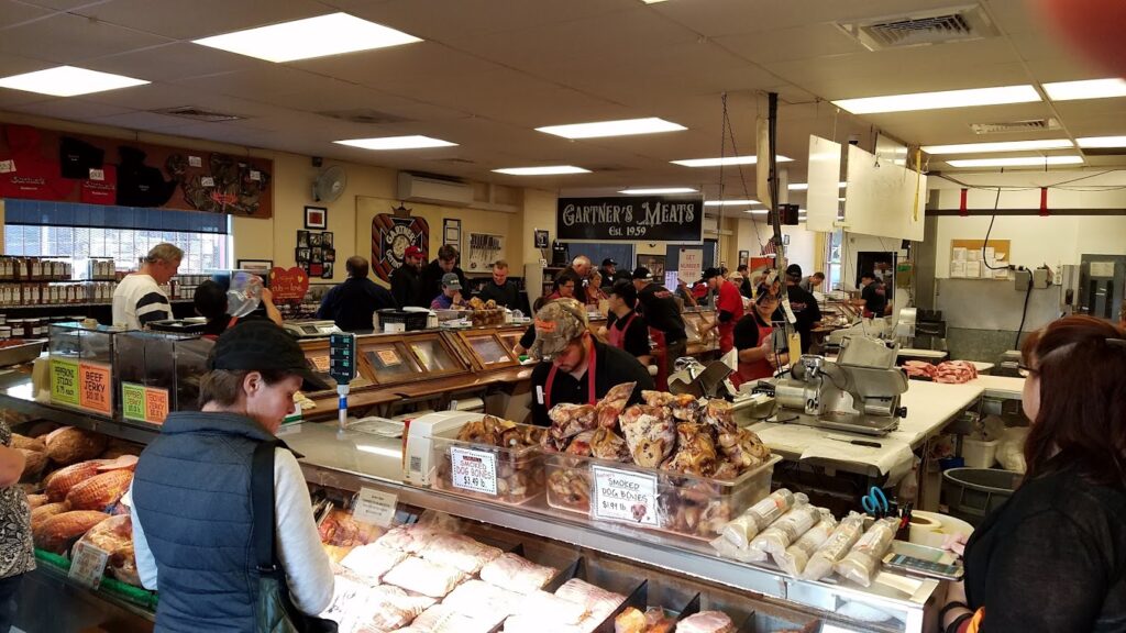 A crowd of people in line inside Gartner's Meat Market.