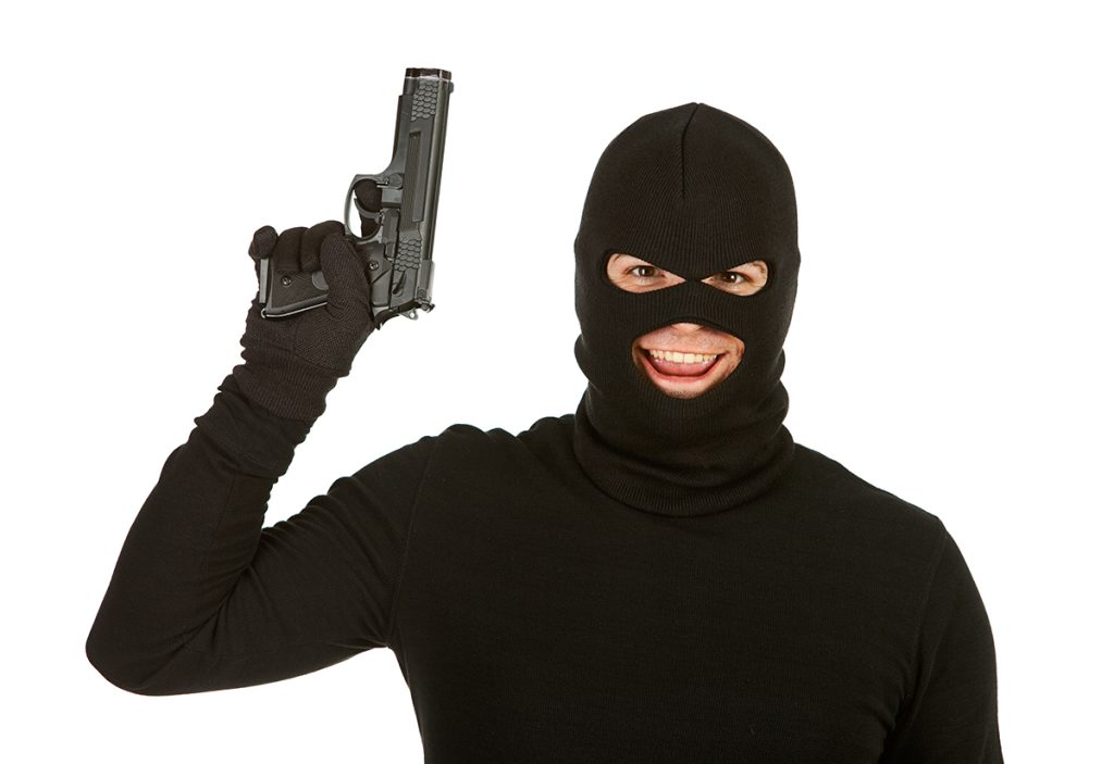 smiling masked man with gun