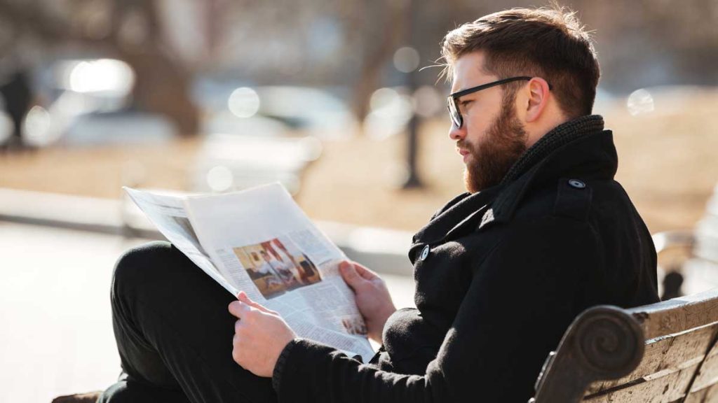 Man reading a newspaper in Portland