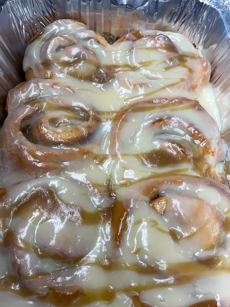 Delicious looking Cinnamon rolls covered in icing.
