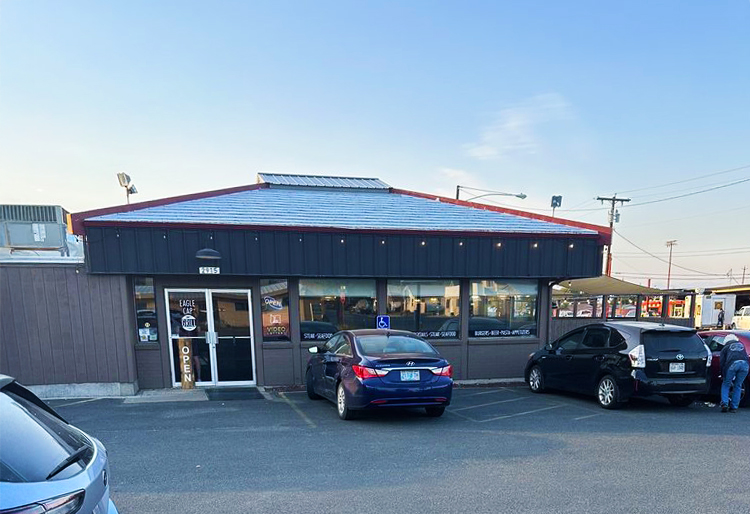 The outside of Eagle Cap Grill. It's a gray restaurant with a gray roof.