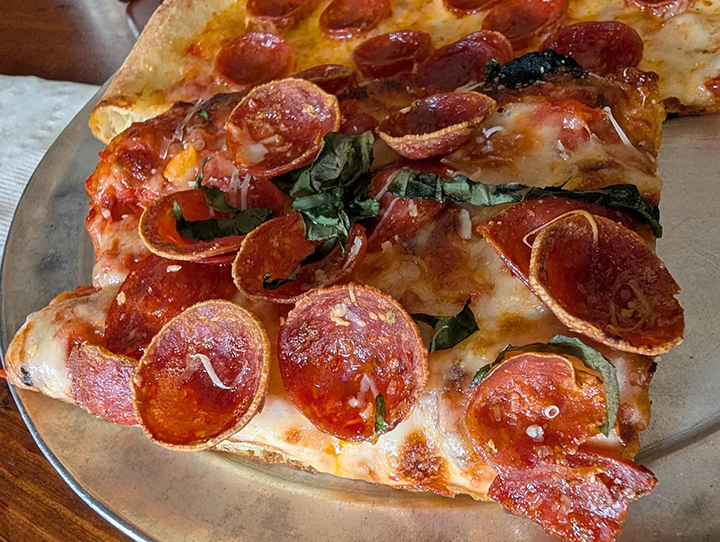 A delicious slice of pepperoni pizza.