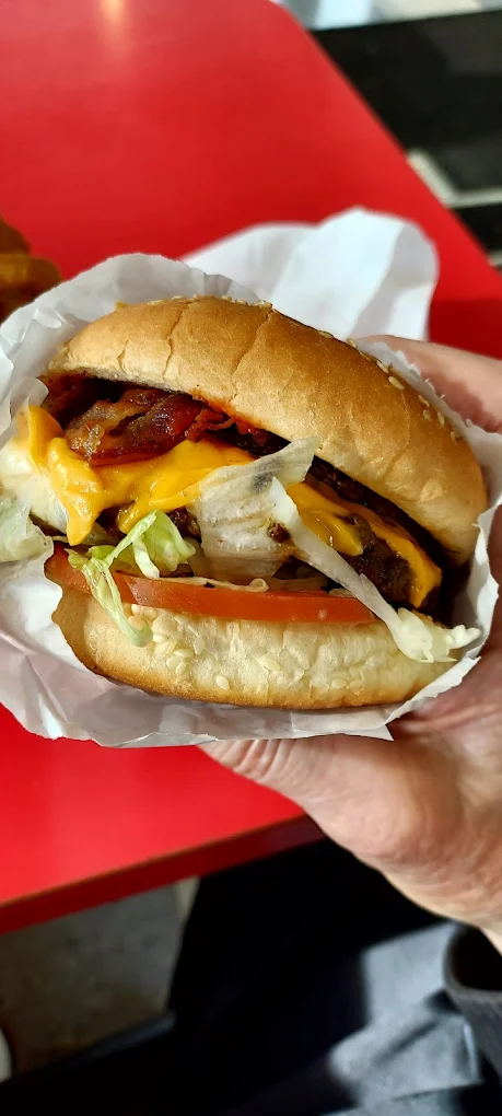 A thick juicy burger with cheese, lettuce and bacon/