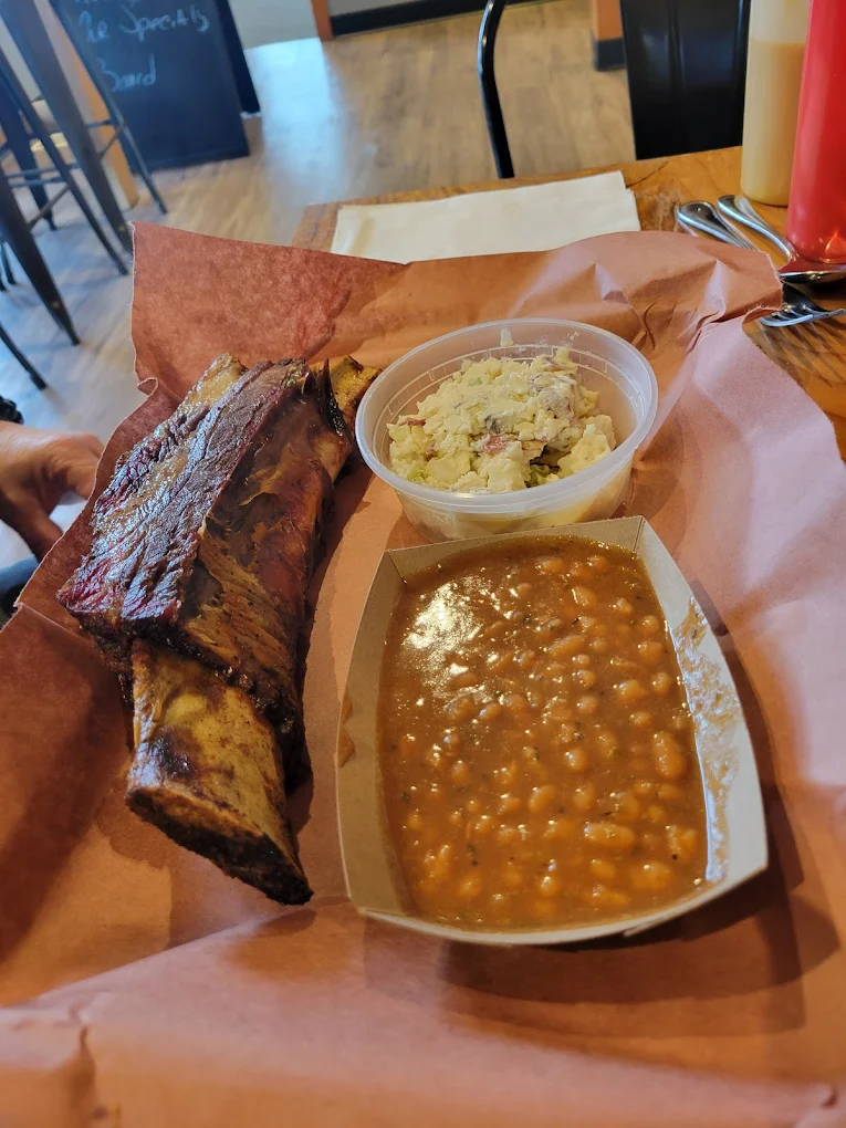 Beans, a side, and a huge slab of smoked meat on the bone.