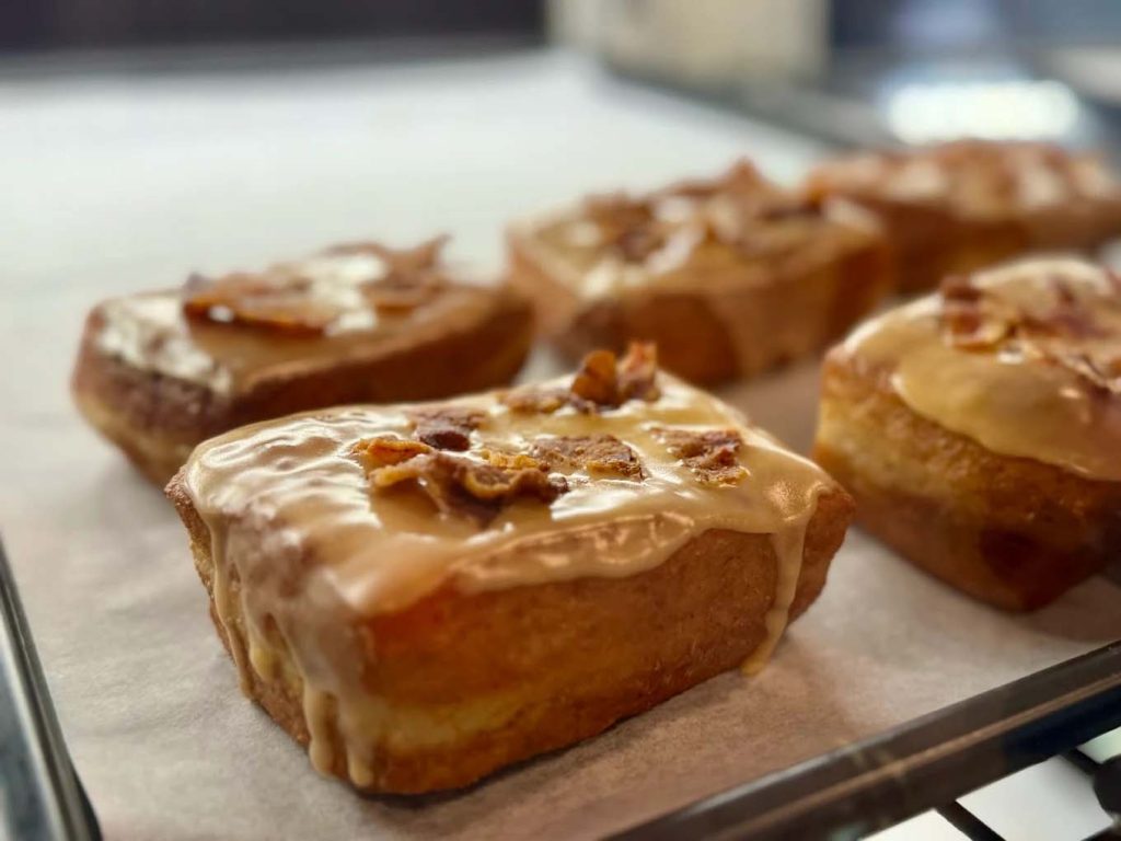Delicious maple glazed donuts with crispy bacon on top. Yum!