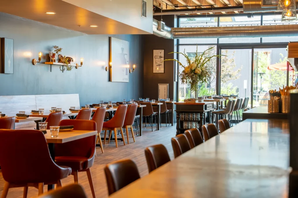 The interior of Rancher Butcher Chef in Bend, Oregon. Warm wood, modern chairs and décor make it a welcoming place to dine.