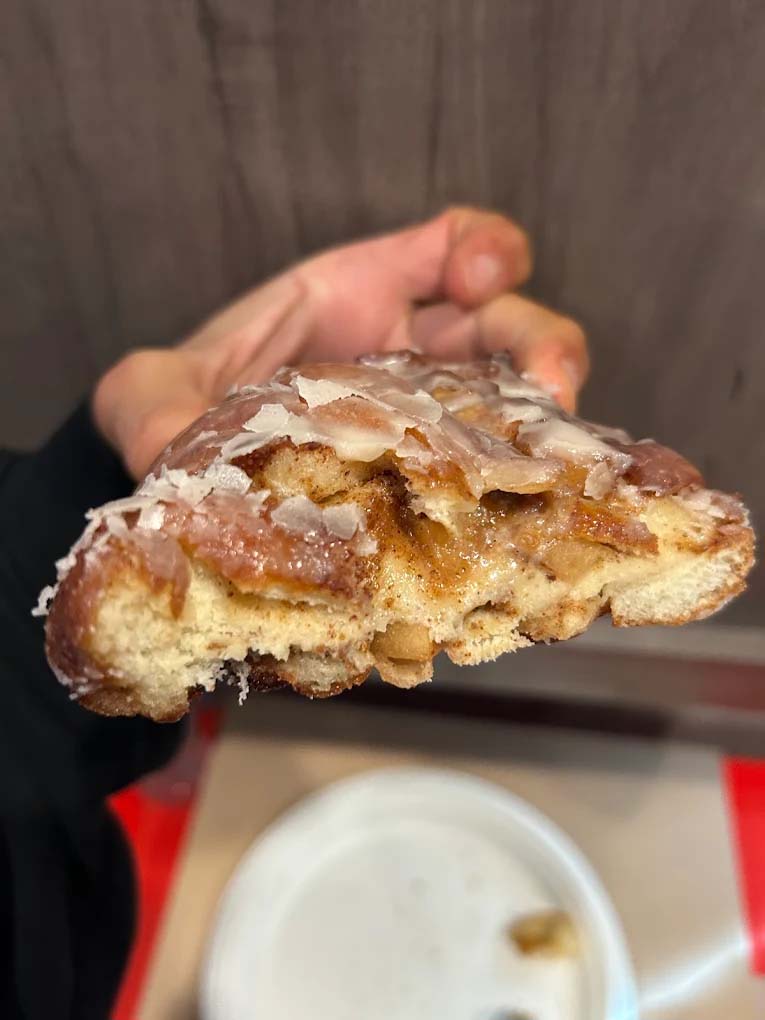 An enormous apple fritter cut in half.