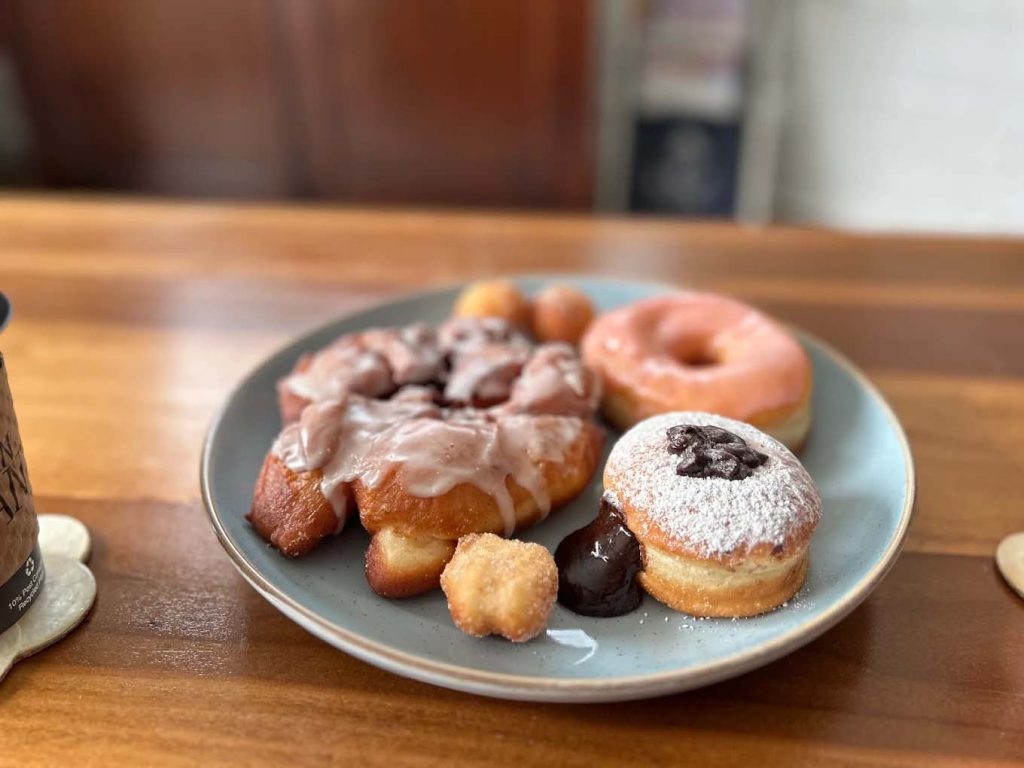 An assortment of delicious fresh donuts on a plate.