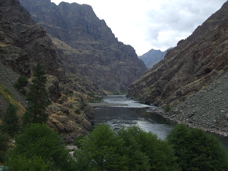 A view of the towering cliffs around the river inside Hell's Canyon.
