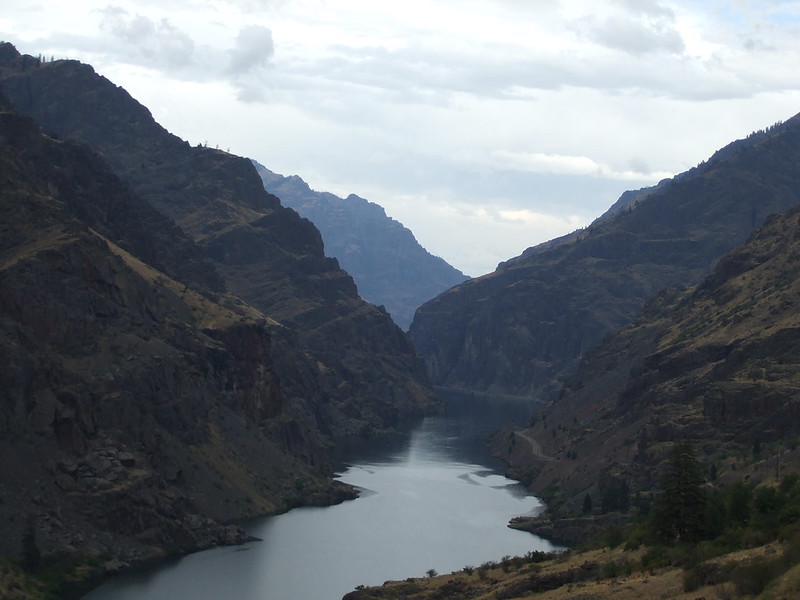 A view of the towering cliffs around the river inside Hell's Canyon.