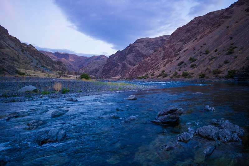 A view of the towering cliffs around the river inside Hell's Canyon.