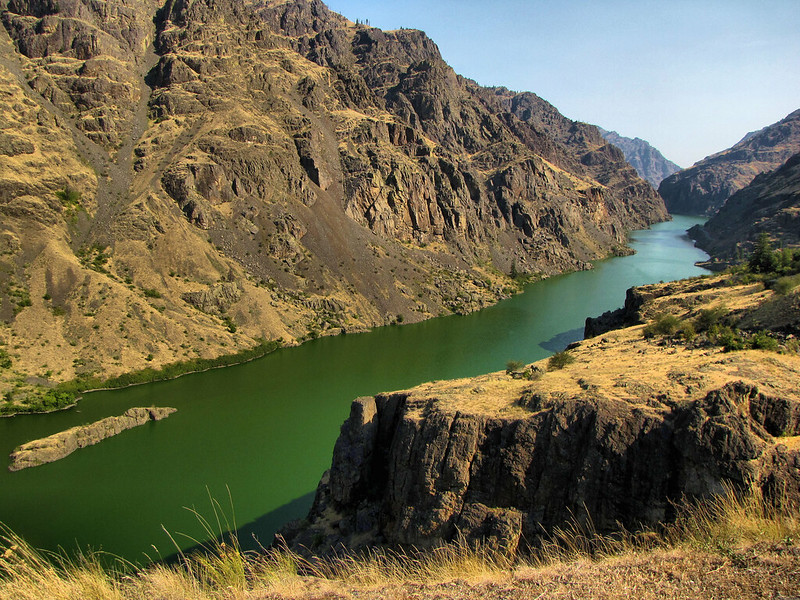 A view of the towering cliffs around the river inside Hell's Canyon.