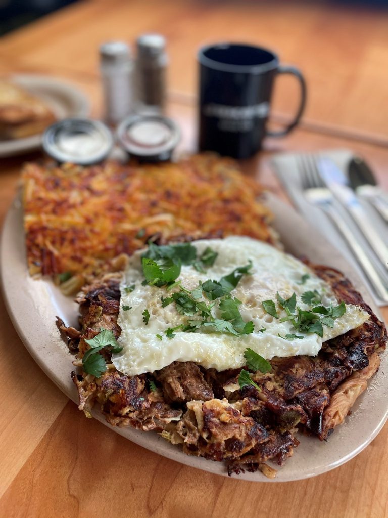 Carnitas Hash with jalapenos, cilantro, and eggs.