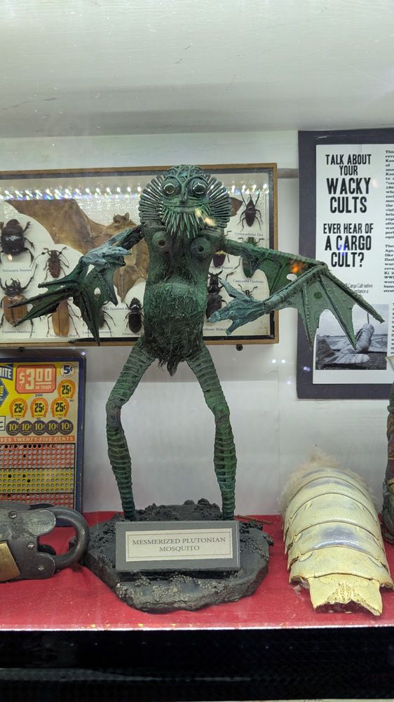 A weird, creepy green merman type statue.