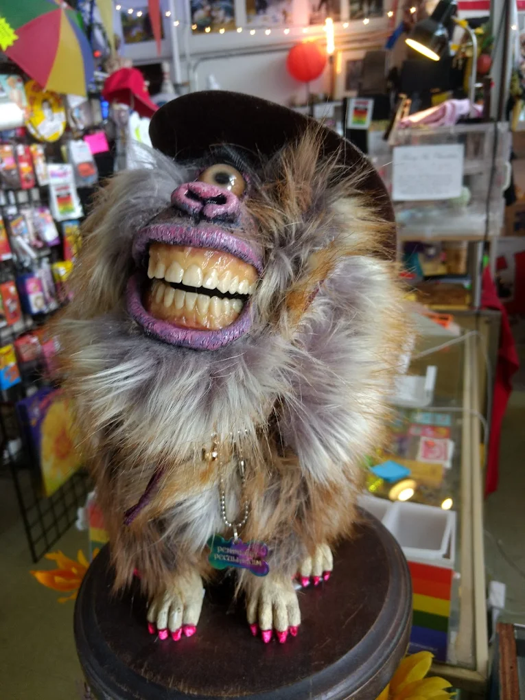A creepy one eyed grinning baboon.