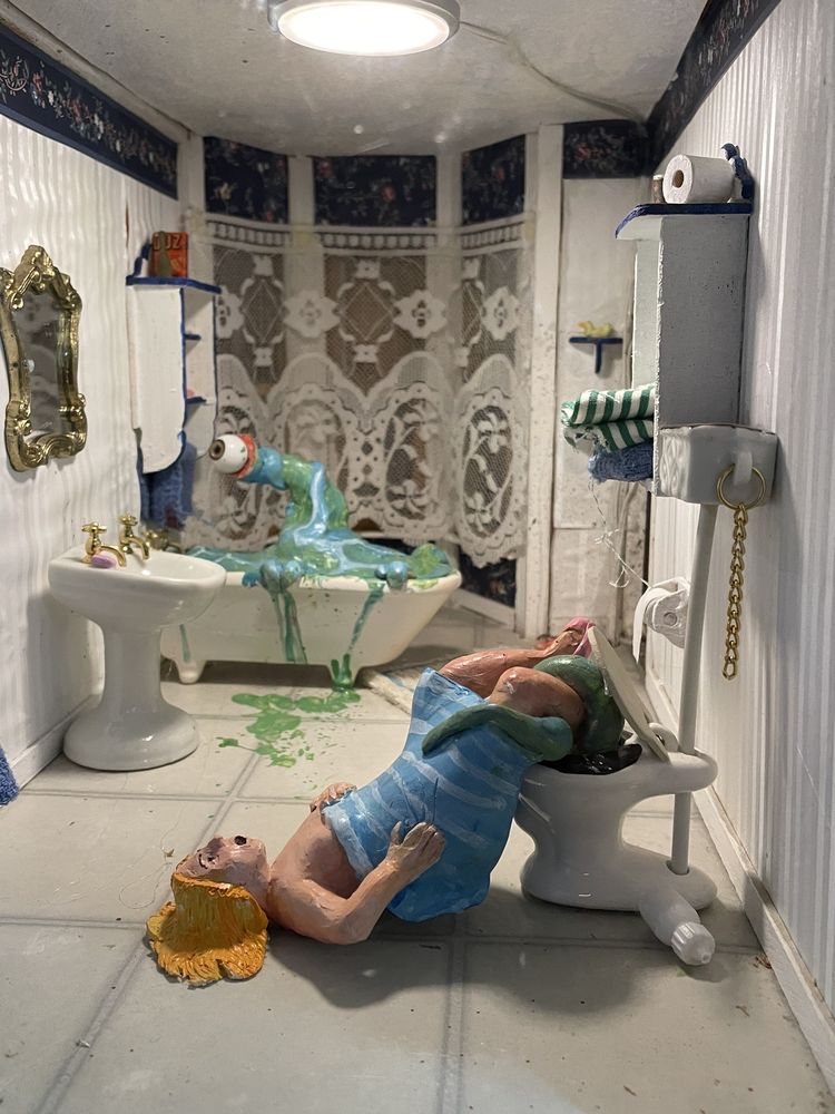 Inside the haunted doll house. A green tentacle comes out of the toilet and tries to eat a woman.