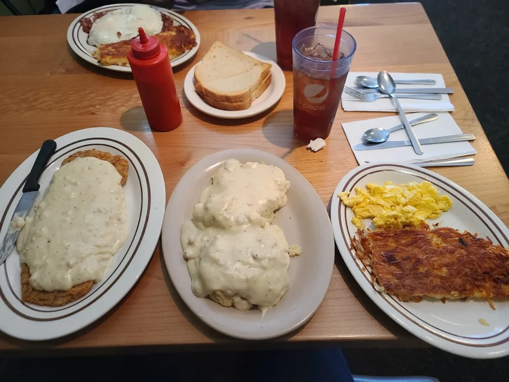 Plates full of massive portion sizes of breakfast foods.