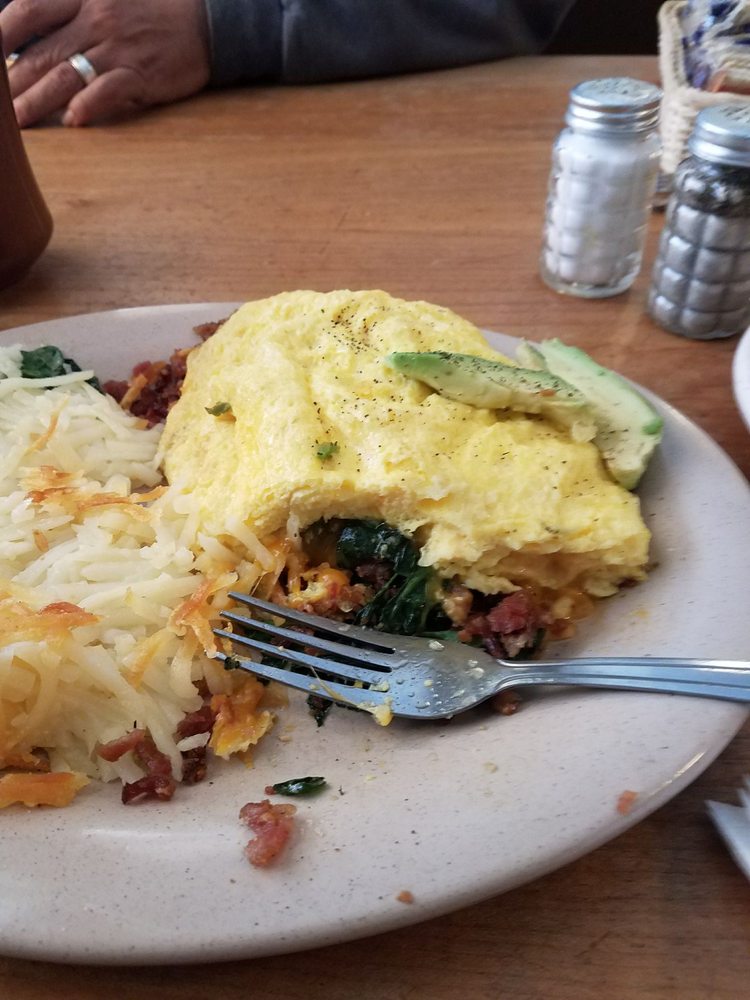 An omelet filled with meat and veggies.