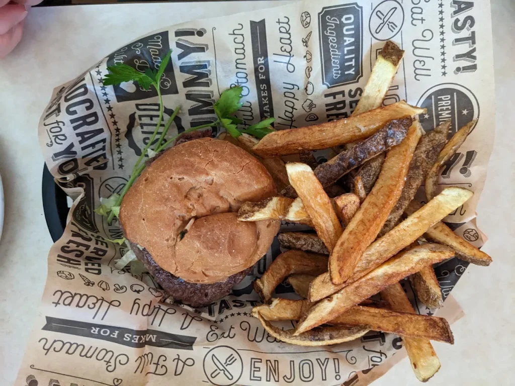 A burger and crazy tasty looking steak fries.