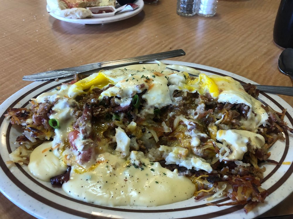 The Stacker corn beef hash with tomatoes, cheese and eggs with hollandaise. At Jake's Diner in Bend, Oregon.