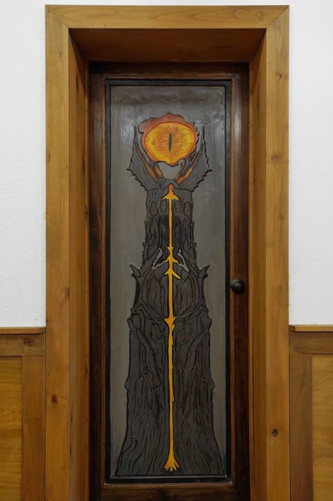 A carved Lord of the Rings door featuring Sauron's eye.