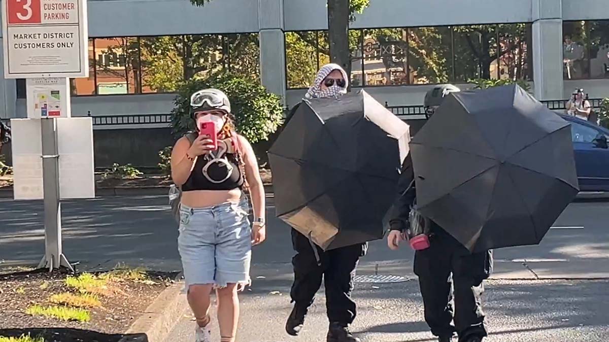 Umbrella protest fashion week in Eugene