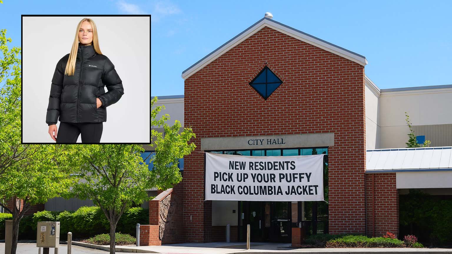 Banner hanging on Bend City Hall reading “New Residents Pick Up Your Puffy Black Columbia Jacket,” referencing a humorous satire about mandatory jackets for newcomers.