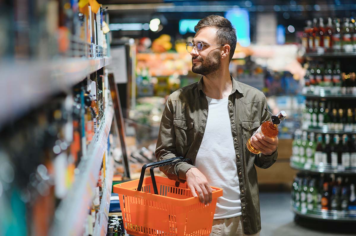 Handsome,Man,Shopping,In,A,Supermarket. Man shopping at grocery store