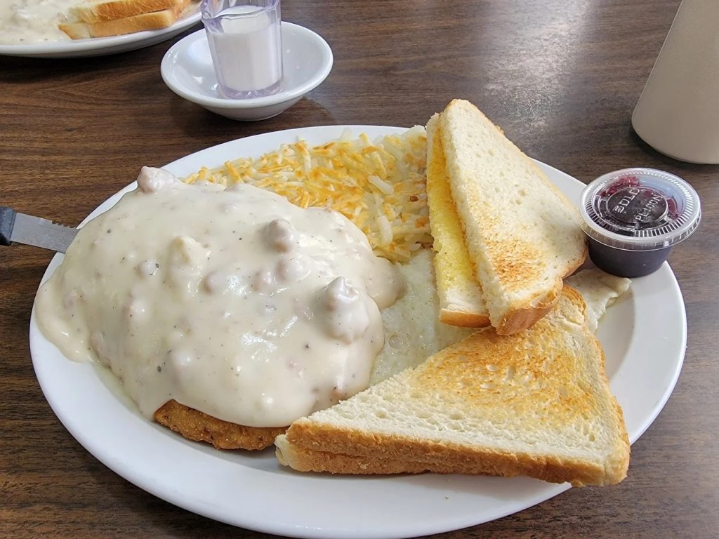 Chicken fried steak smothered in country gravy with hash browns and toast at The Berry Patch Restaurant Oregon Coast