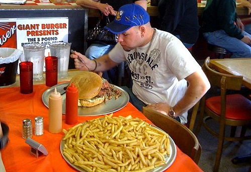 A man attempts to eat a five pound hamburger, and five pounds of fries at Giant Burger in Springfield, Oregon.