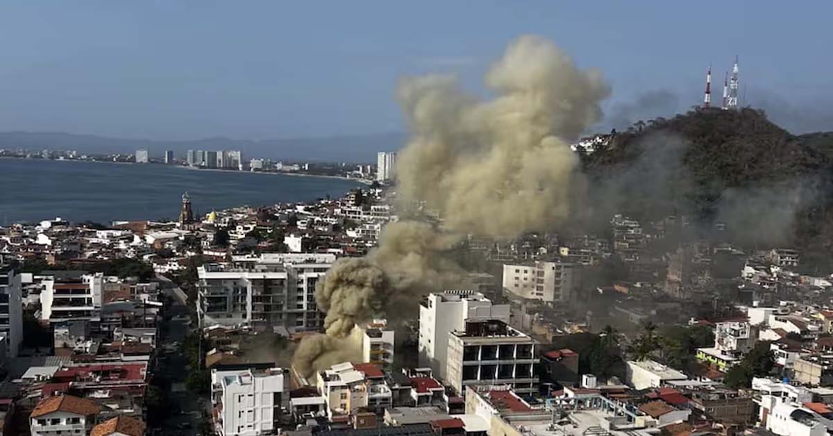 mexico_war_zone Smoke rising over buildings in Puerto Vallarta, Mexico, as seen from a residential balcony.