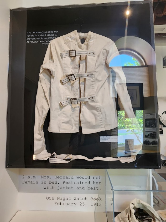Straightjacket display inside OSH Museum of Mental Health in Salem Oregon showing historic restraint device used in early psychiatric treatment