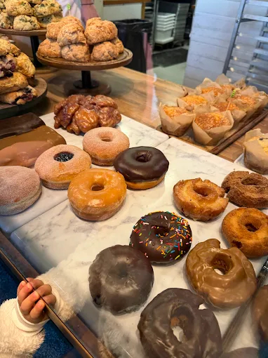 Fresh baked sweets and bread in a small-town bakery with natural light and rustic charm