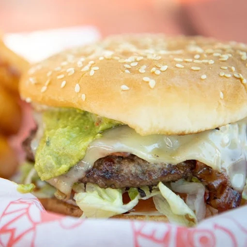 Cheeseburger with guacamole and melted cheese at Mike’s Drive-In Oregon burger joint