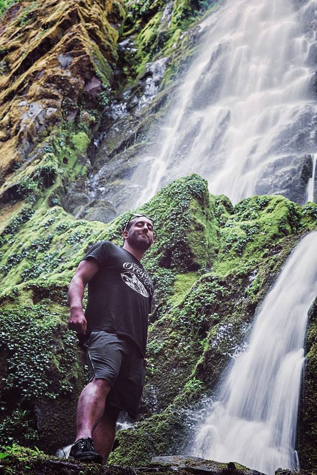 Tyler James exploring an Oregon waterfall