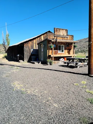 A rustic ranch building and picnic table at Wilson Ranches Retreat near Fossil