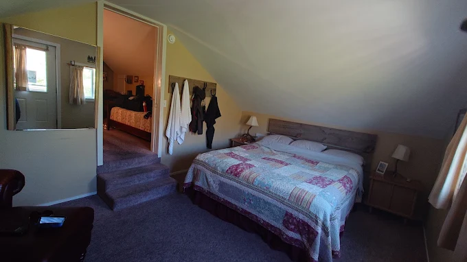 An upstairs bedroom with a quilted king bed at Wilson Ranches Retreat
