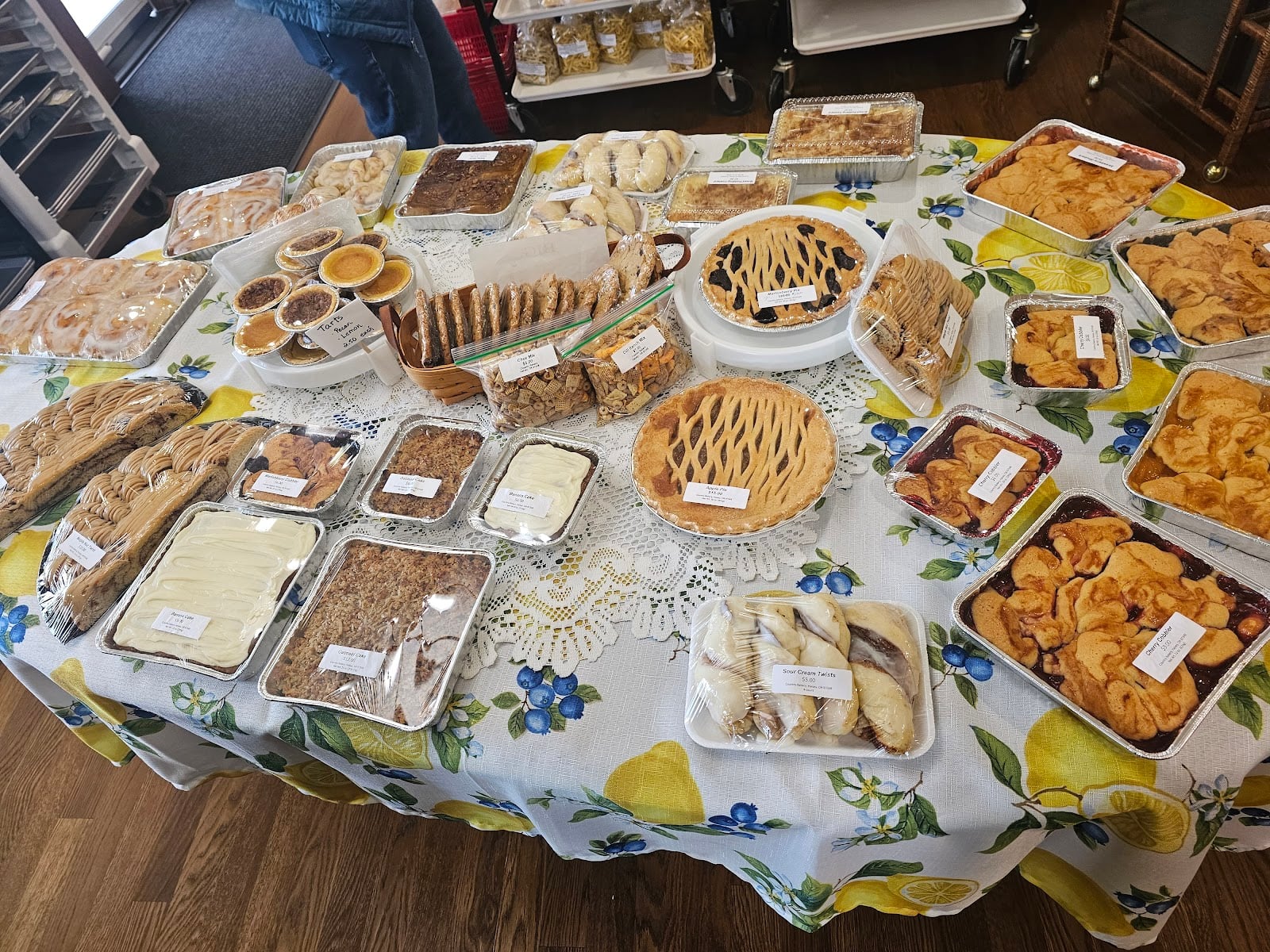 Pies, cobblers, cookies, and iced pastries cover a table at Country Bakery.