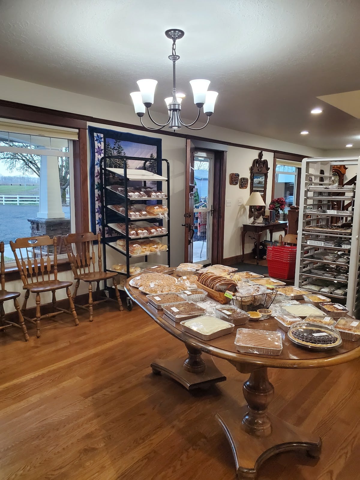 A wooden table and bakery racks fill the home-style interior of Country Bakery.